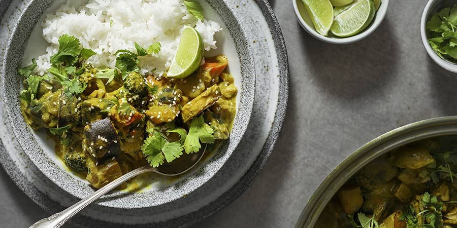 Vegetable curry with rice, lentils, and limes