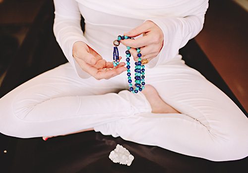 holding mala beads