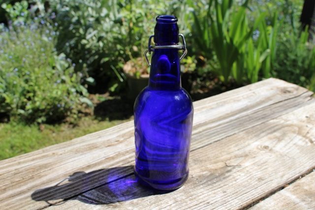 water in a blue glass bottle